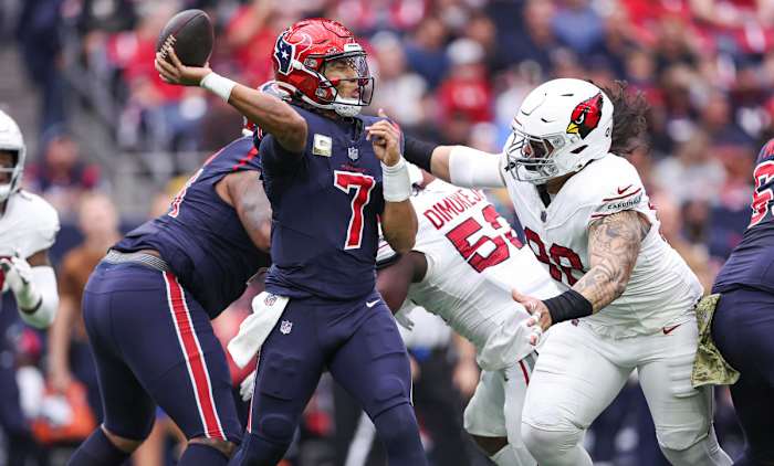 Nov 19, 2023; Houston, Texas, USA; Houston Texans quarterback C.J. Stroud (7) attempts a pass as Arizona Cardinals defensive tackle Roy Lopez (98) applies defensive pressure during the first quarter at NRG Stadium. Mandatory Credit: Troy Taormina-USA TODAY Sports